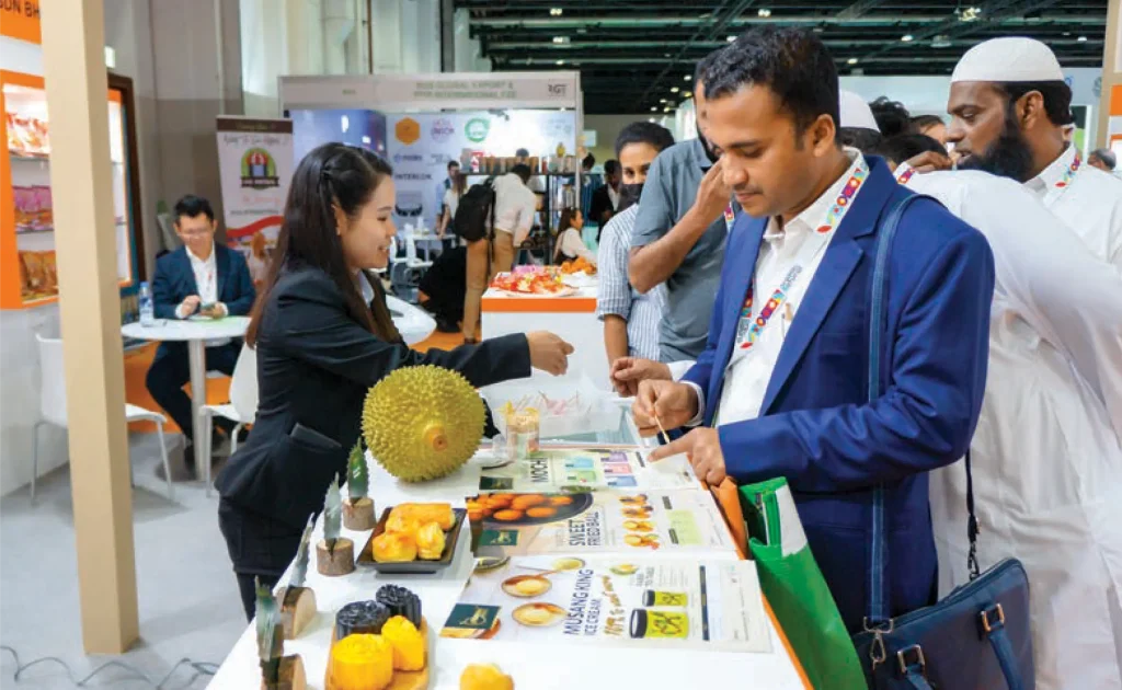 Trade visitors trying Malaysian durian.